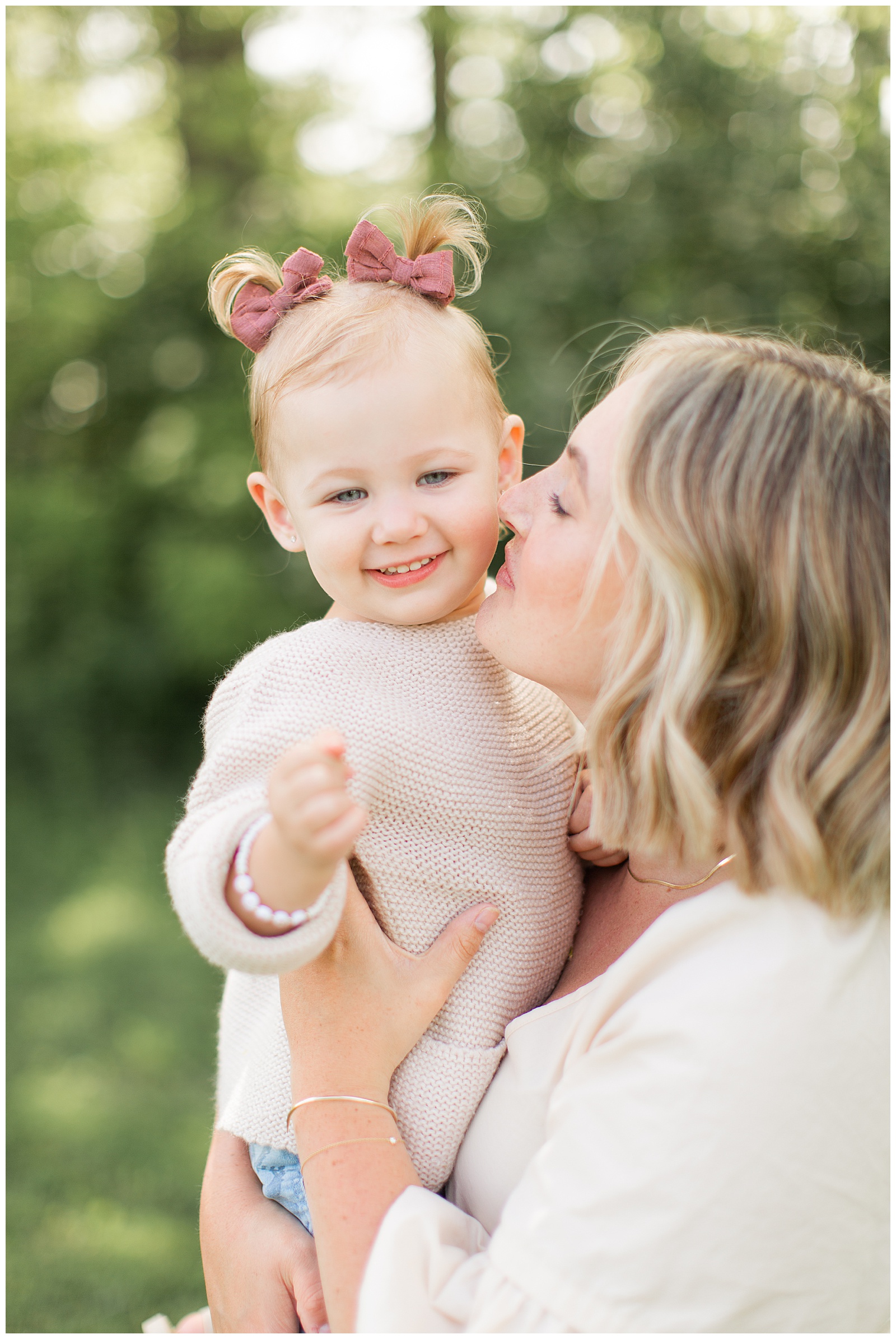 Mother kissing daughter on cheek family session